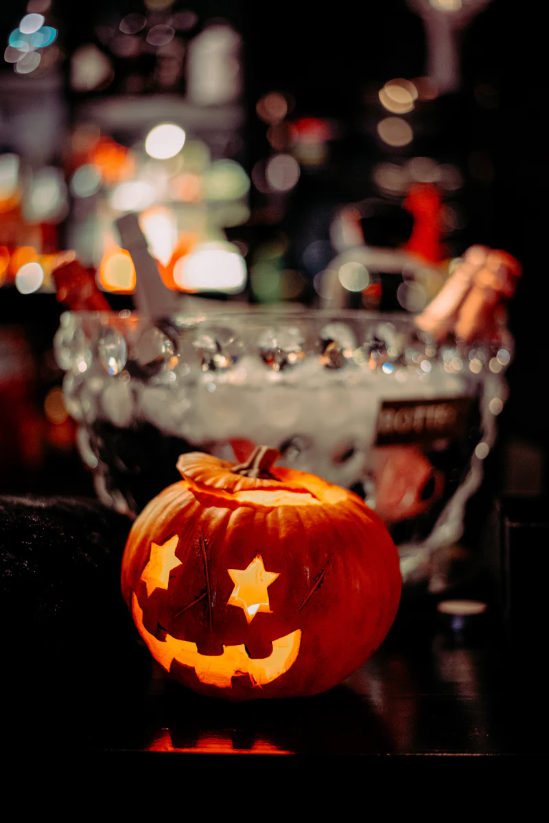 Glowing carved jack-o'-lantern held up at night
