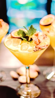 A vibrant cocktail garnished with fresh fruit, showcasing Tawanda's mixology skills.