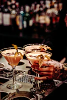 Close-up of premium cocktails served on a minimalist bar counter, reflecting refined taste.