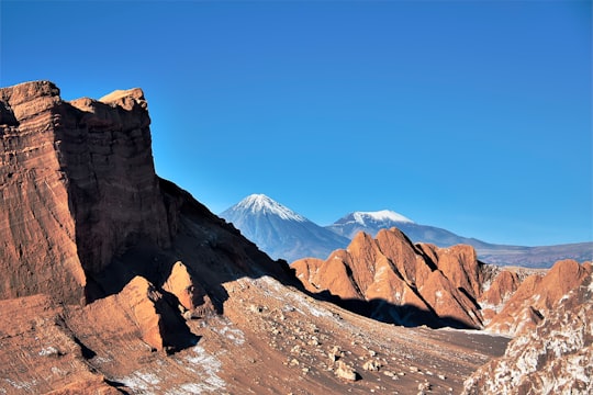 brown rocky mountain under blue sky during daytime in Atacama Chile