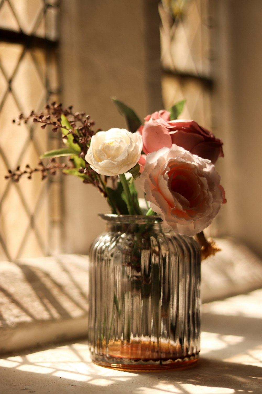 pink roses in clear glass vase