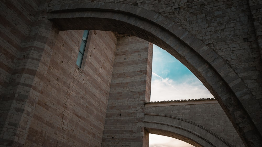 brown brick arch under blue sky during daytime