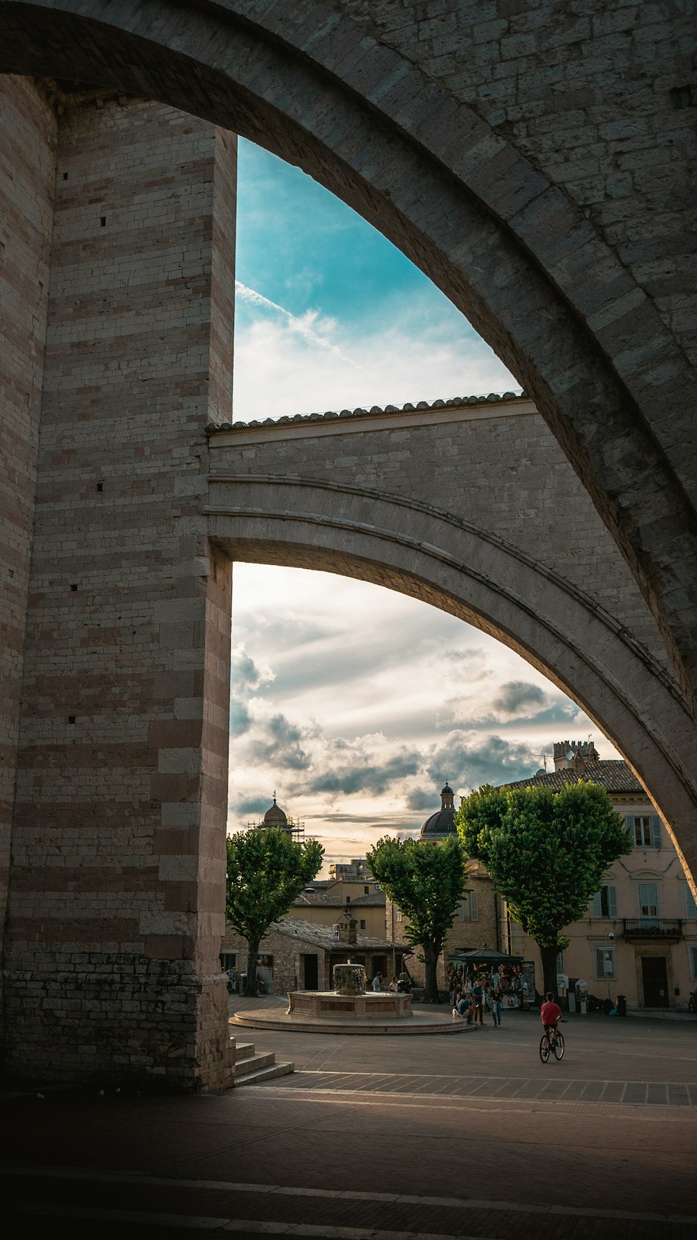 brown brick arch under blue sky during daytime