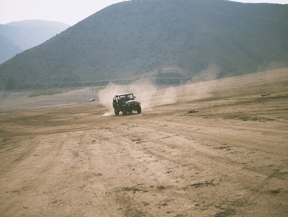 black suv on brown dirt road during daytime