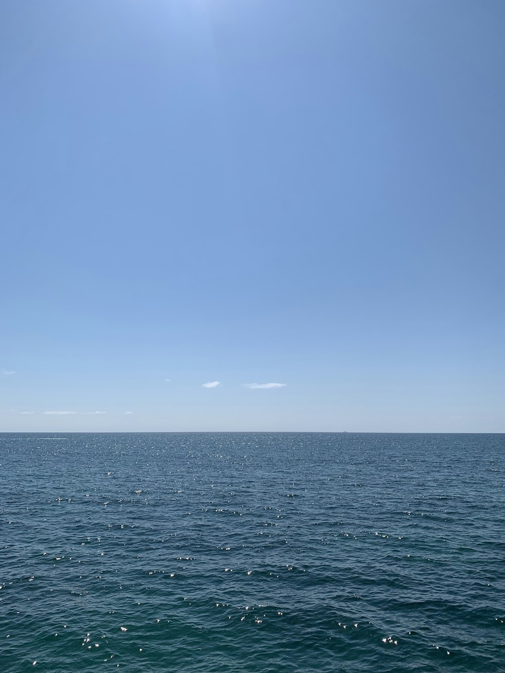 blue ocean under blue sky during daytime