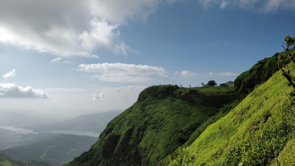 green grass covered mountain under blue sky during daytime