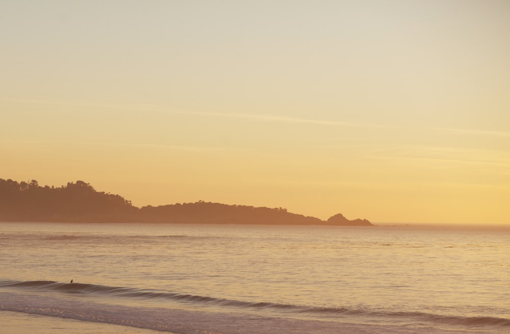 body of water during sunset