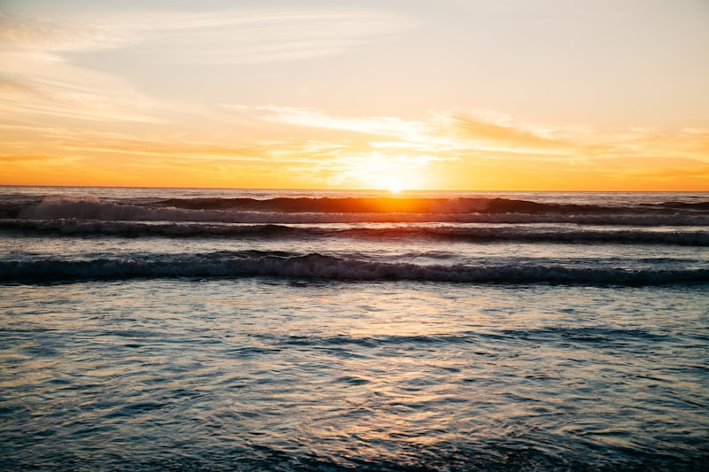 Golden sunset over calm ocean water