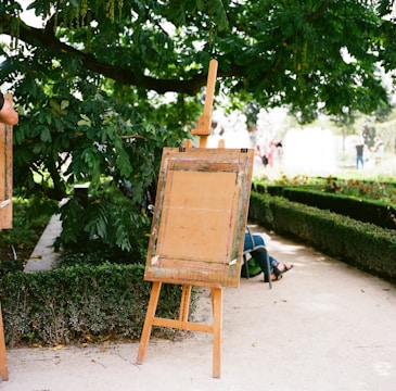 brown wooden folding chair on green grass field