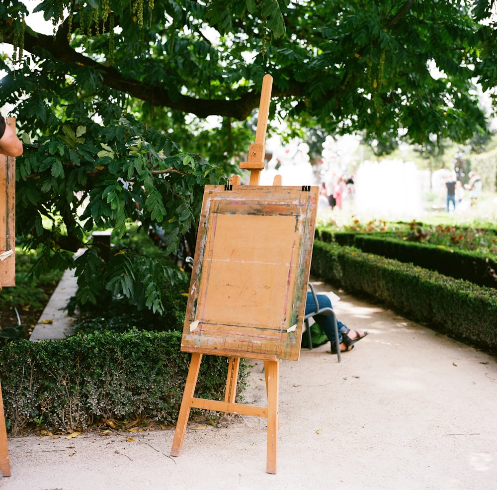 brown wooden folding chair on green grass field