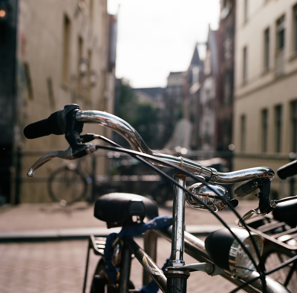 black city bike parked on sidewalk during daytime