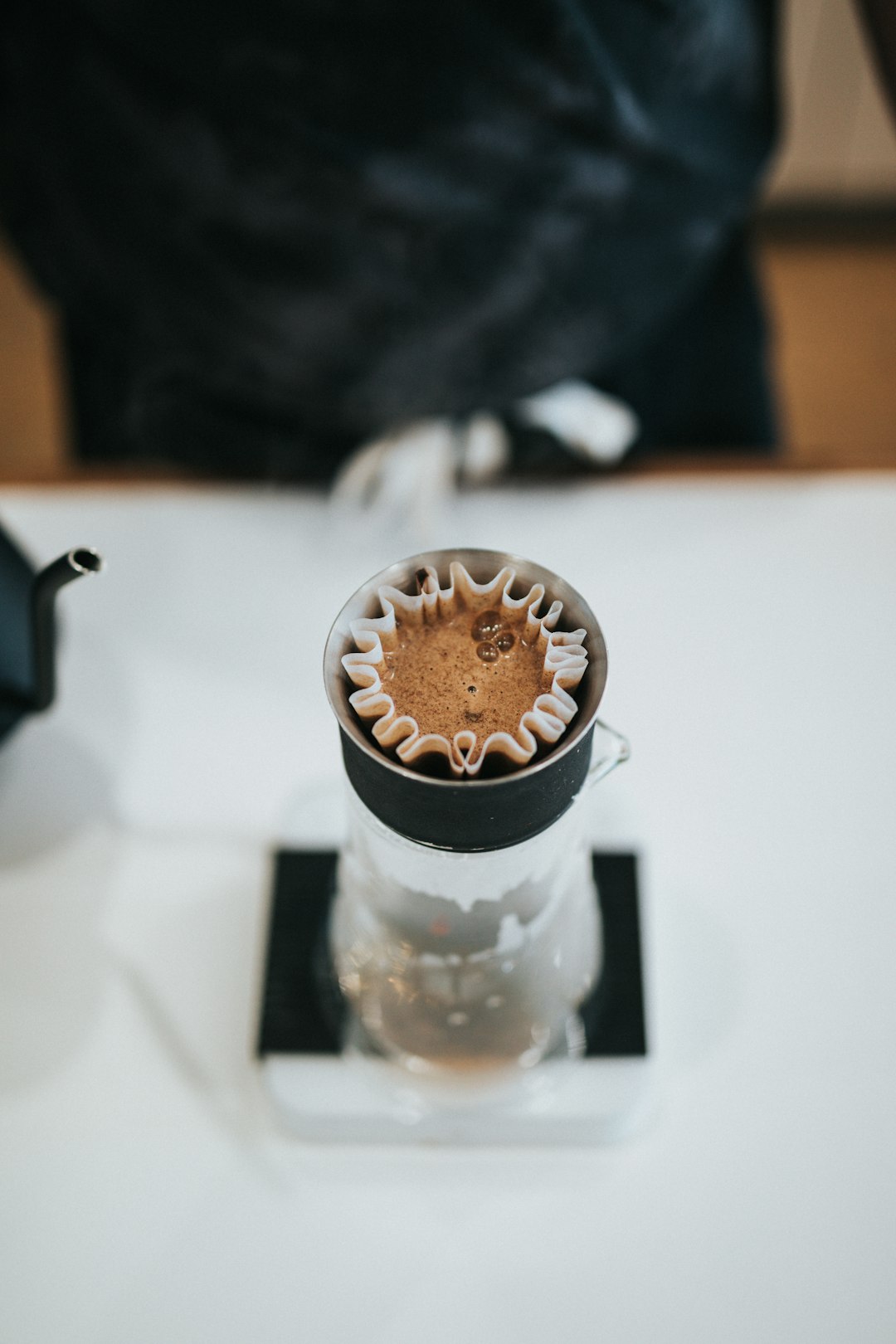 clear glass cup with brown liquid