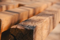 Close-up of premium plywood sheets stacked neatly beside polished metallic hardware pieces under warm lighting.
