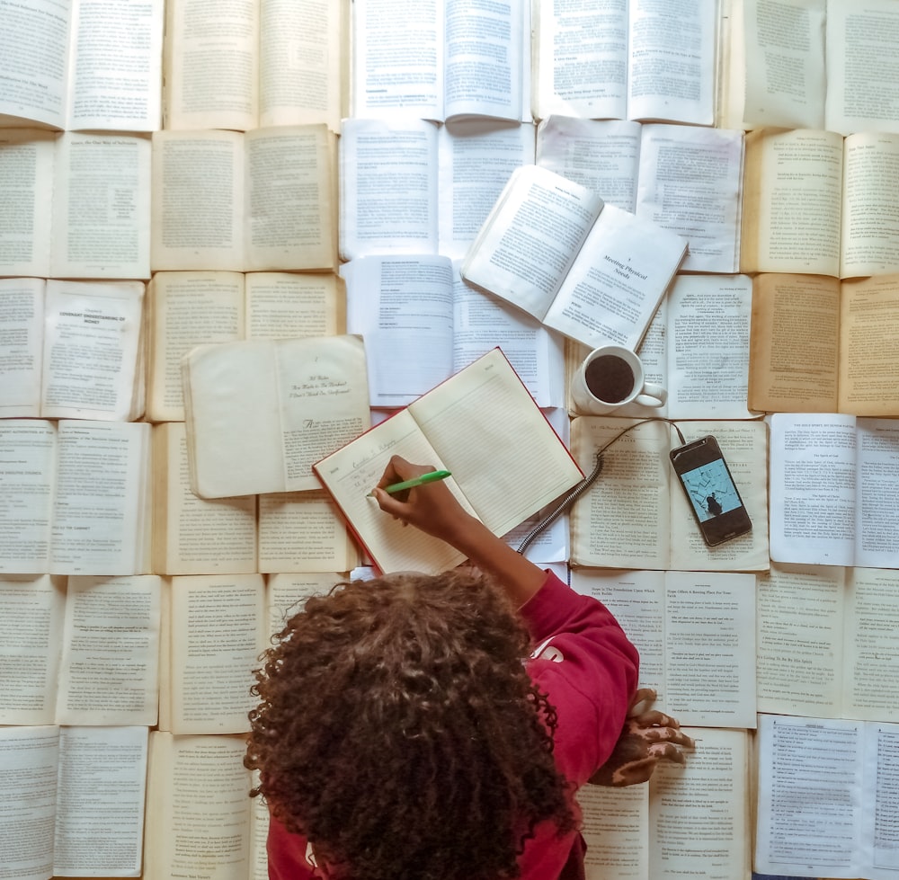 girl in pink shirt reading book