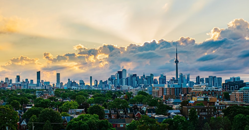 city buildings under white clouds and blue sky during daytime