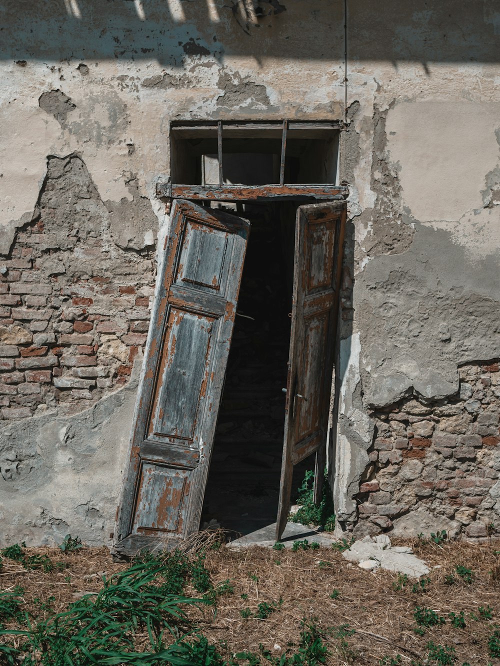 brown wooden door on brown brick wall