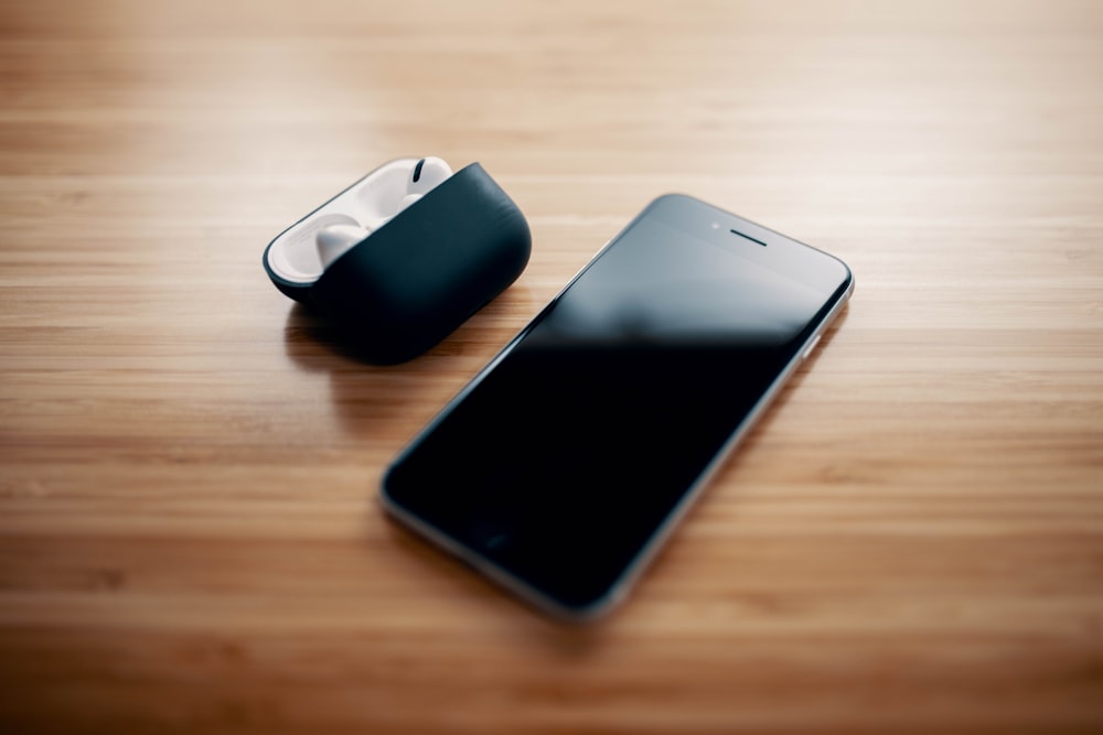 black iphone 7 on brown wooden table