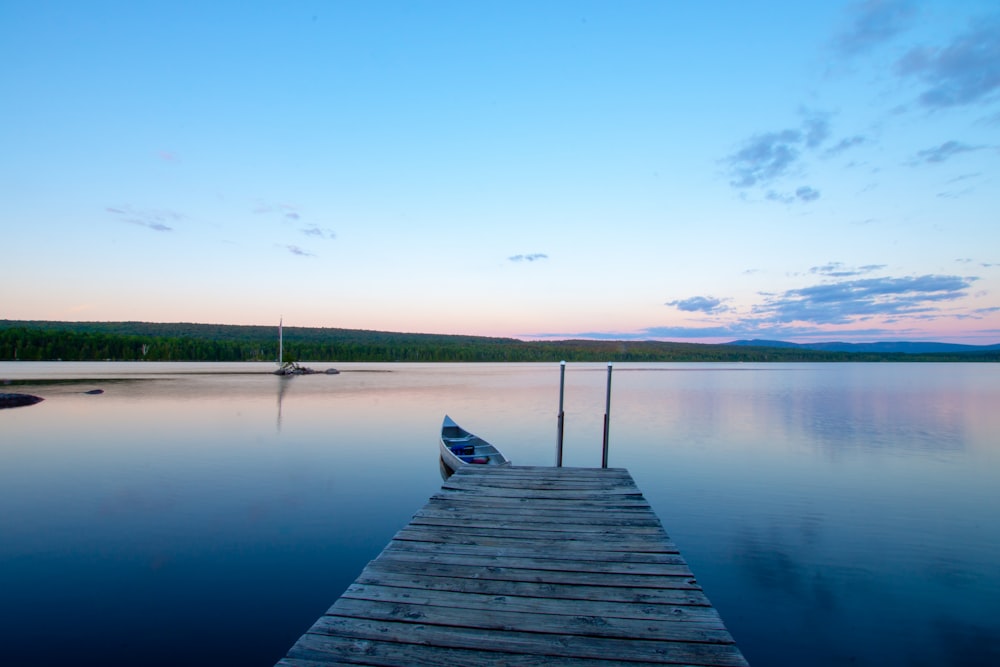 brown wooden dock on lake during daytime