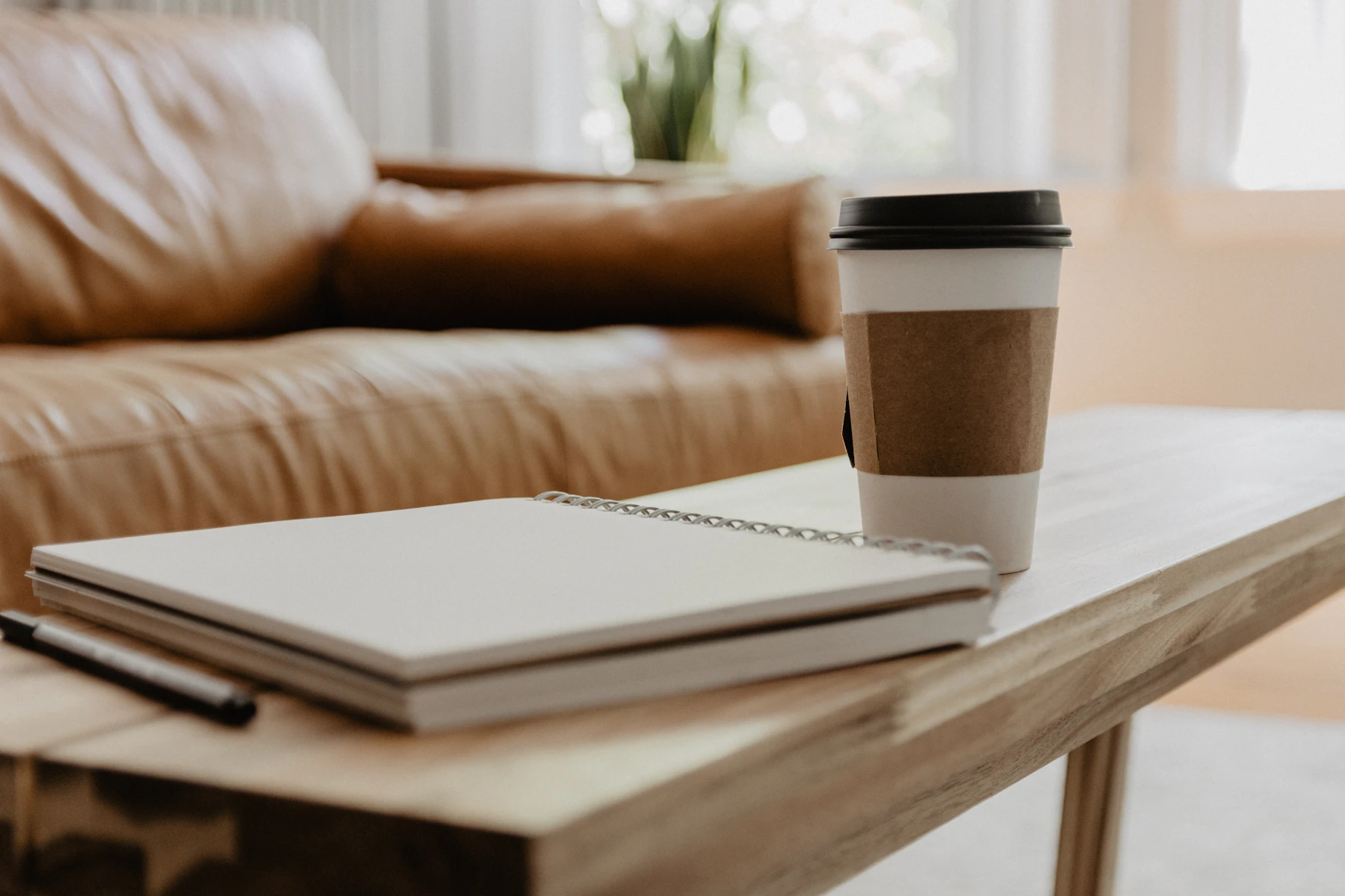 Coffee cup resting on an open notebook