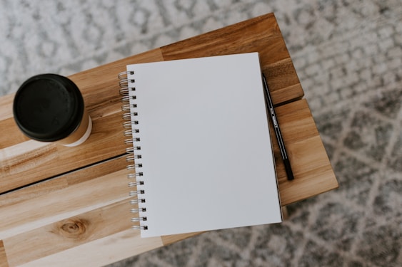 white printer paper on brown wooden table