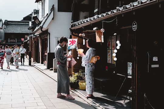 man and woman standing on sidewalk during daytime in Kawagoe Japan