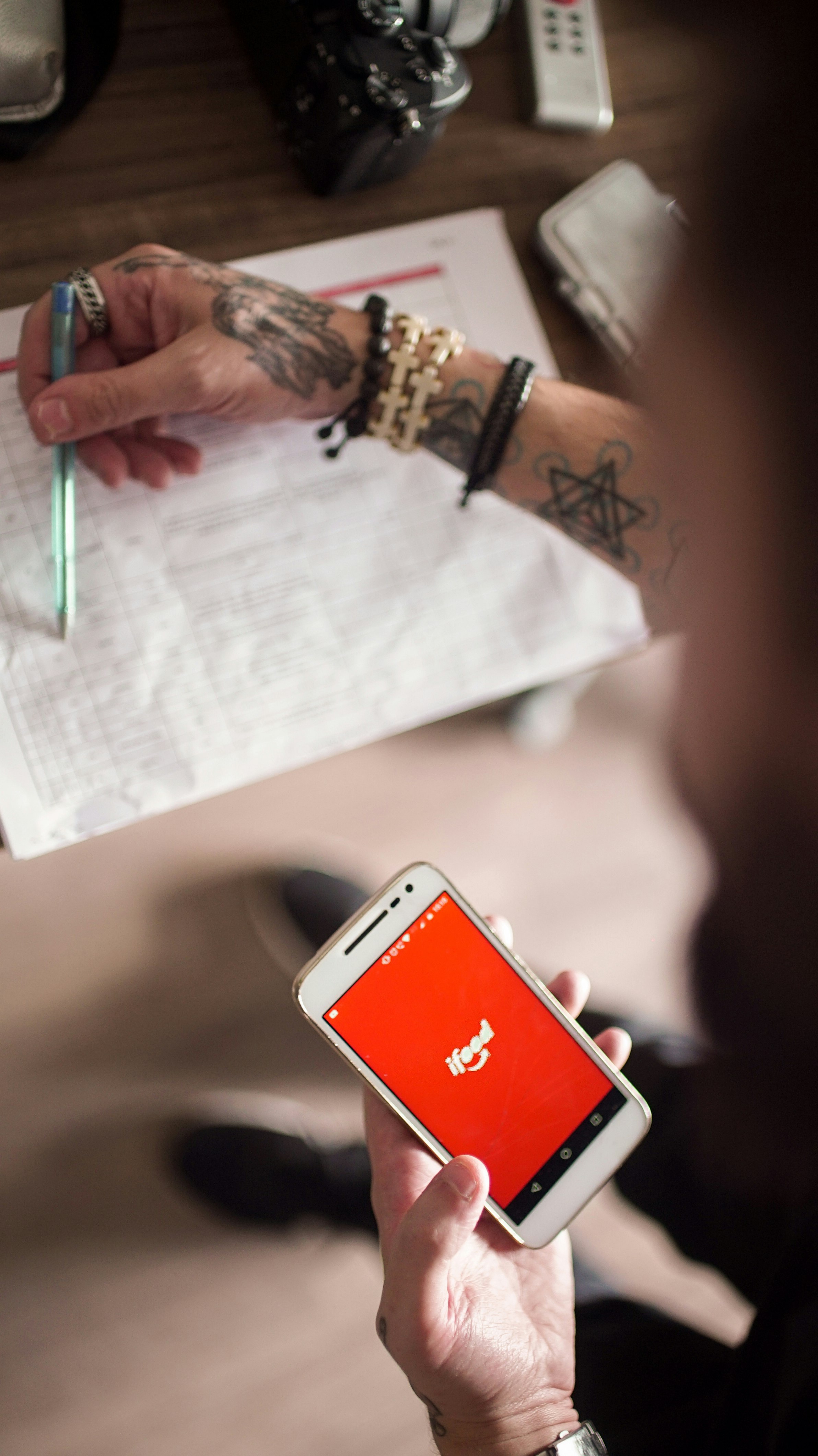 person holding white smartphone with red case