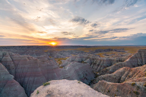 Sunset over the red rock formations at Talampaya National Park with a group of hikers admiring the view.
