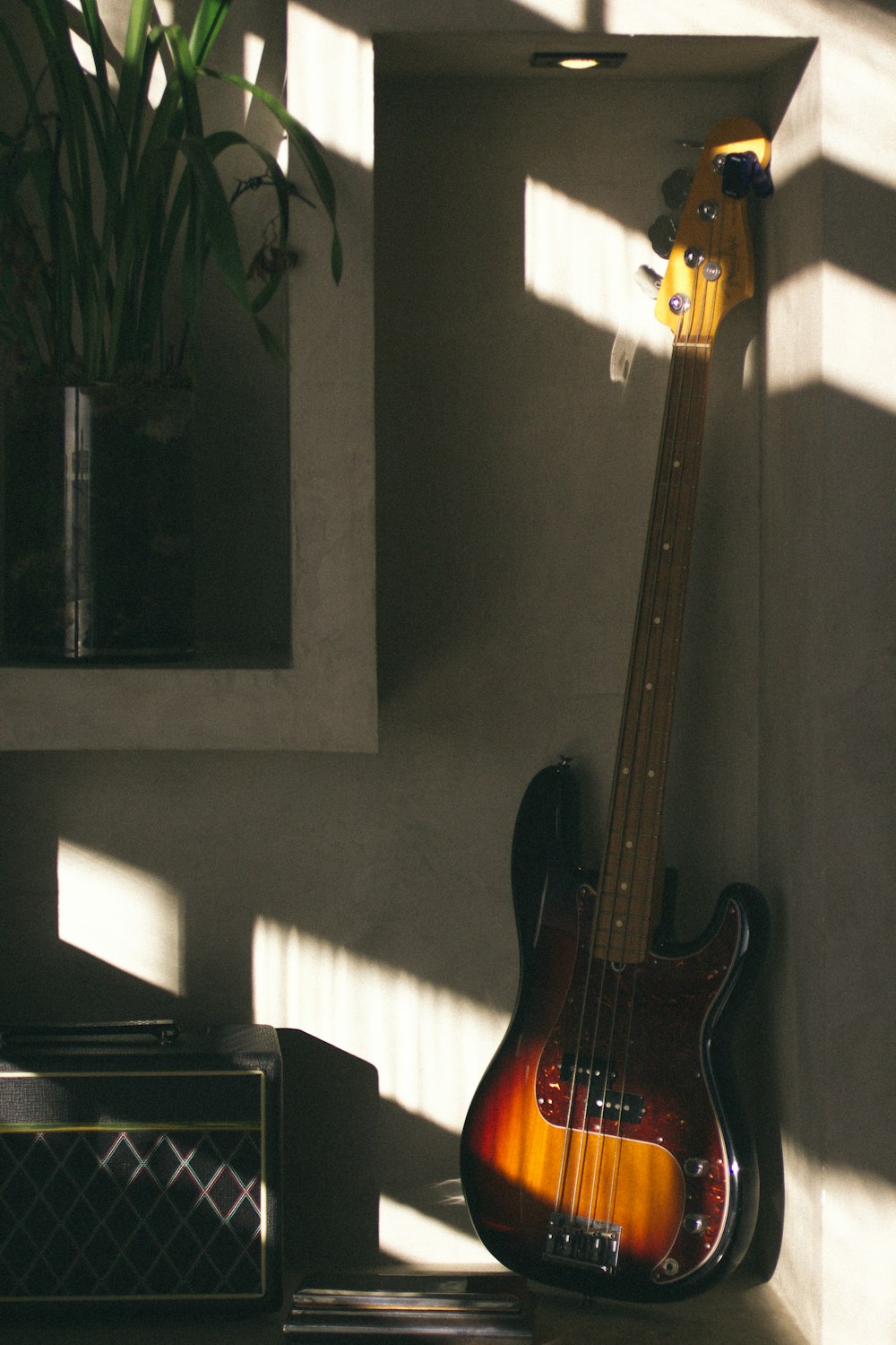 brown electric guitar on black guitar stand