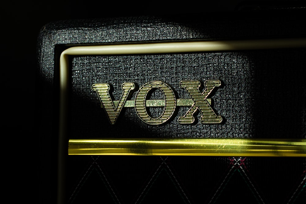 a close up of a black and gold amplifier