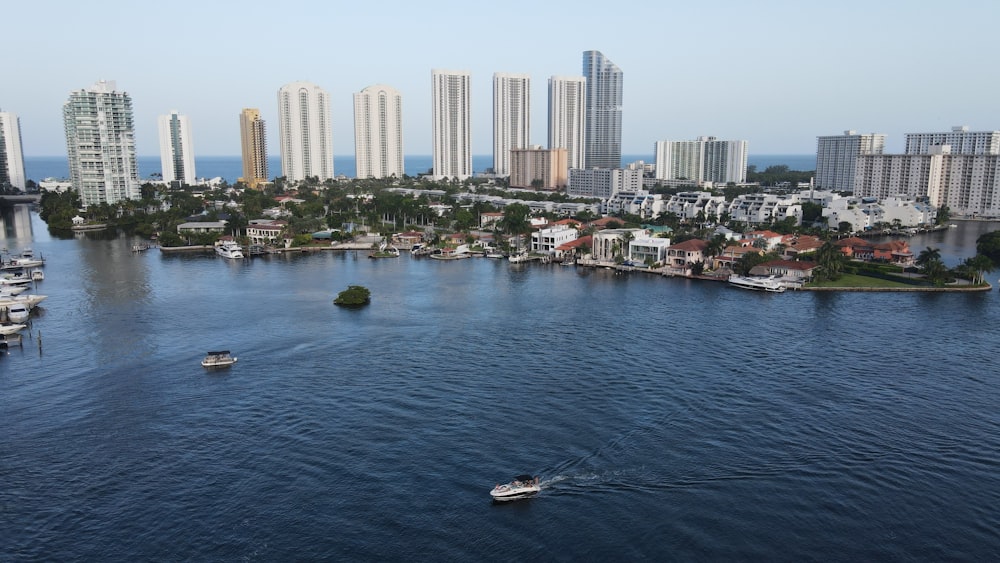 white boat on water near city buildings during daytime