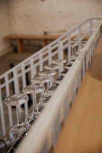 A collection of second pour glasses displayed elegantly on a rustic wooden table.