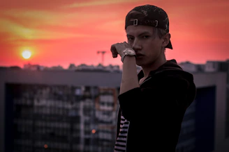 A vibrant streetwear outfit displayed on a city rooftop at sunset.