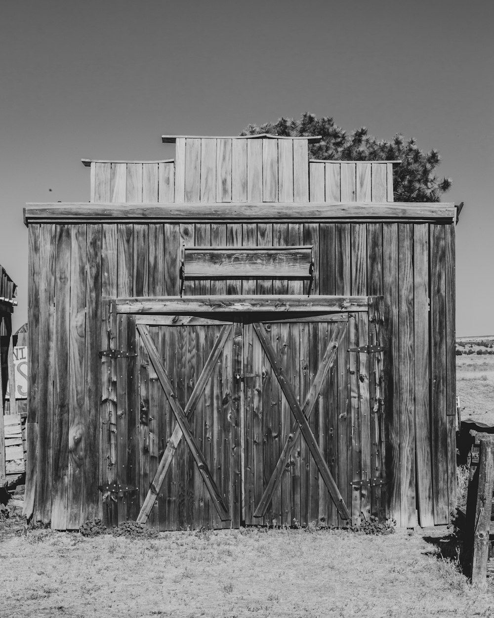 grayscale photo of wooden fence