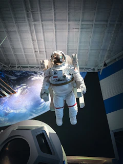 man in white and black suit standing on white and blue floor