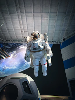 man in white and black suit standing on white and blue floor