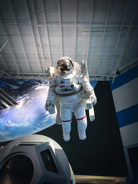 astronaut in white and black spacesuit in space