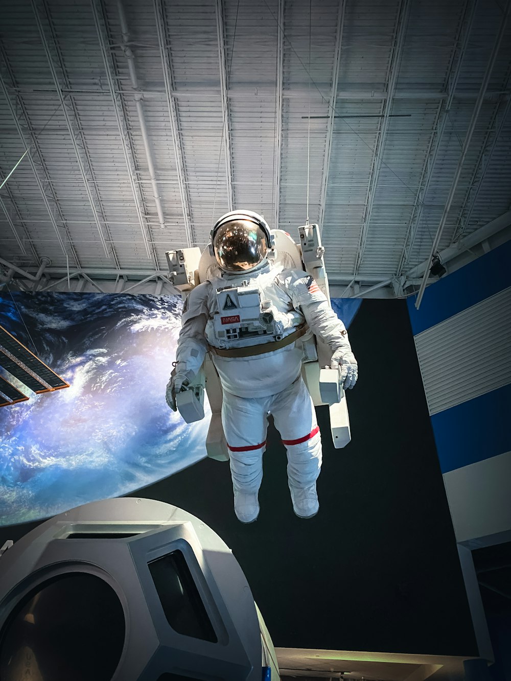 man in white and black suit standing on white and blue floor