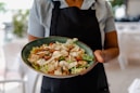 person holding green ceramic plate with food