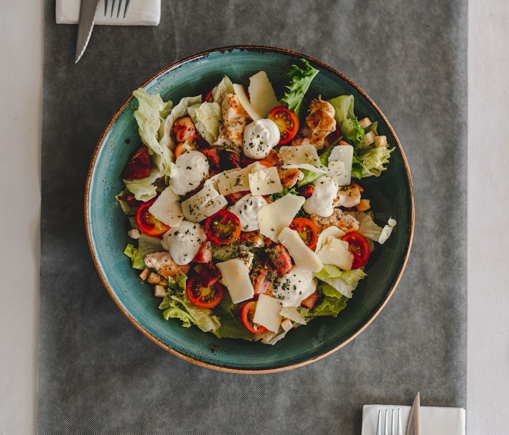 vegetable salad on blue ceramic bowl