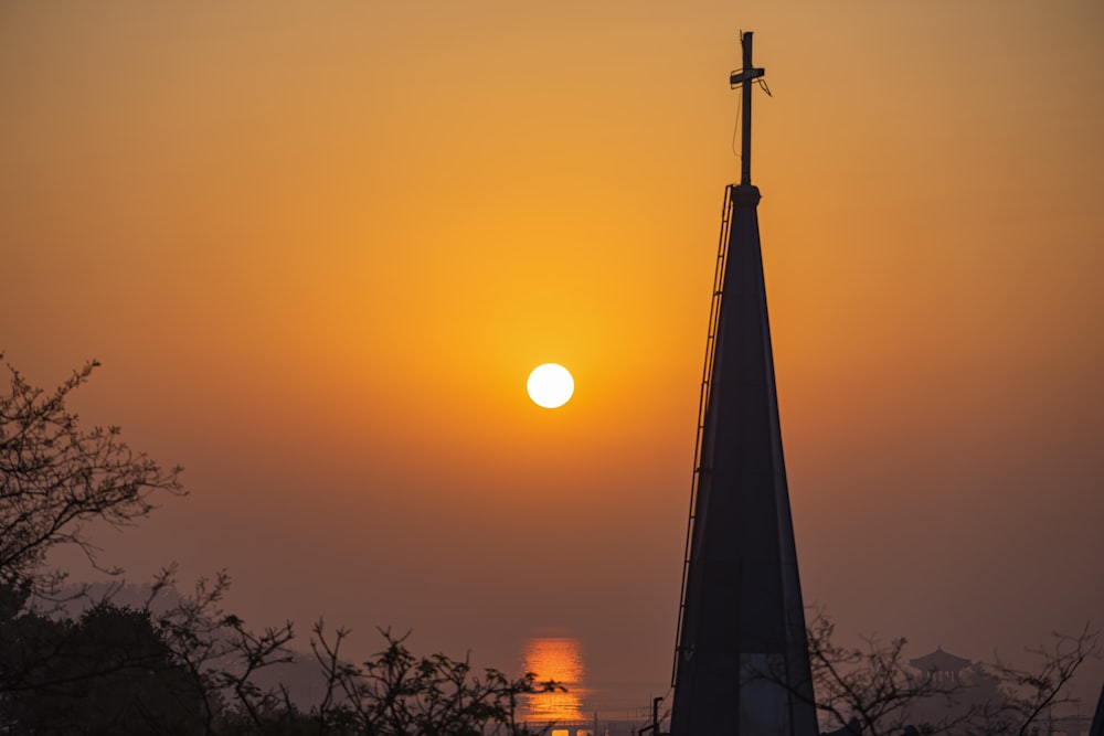 silhouette of cross during sunset