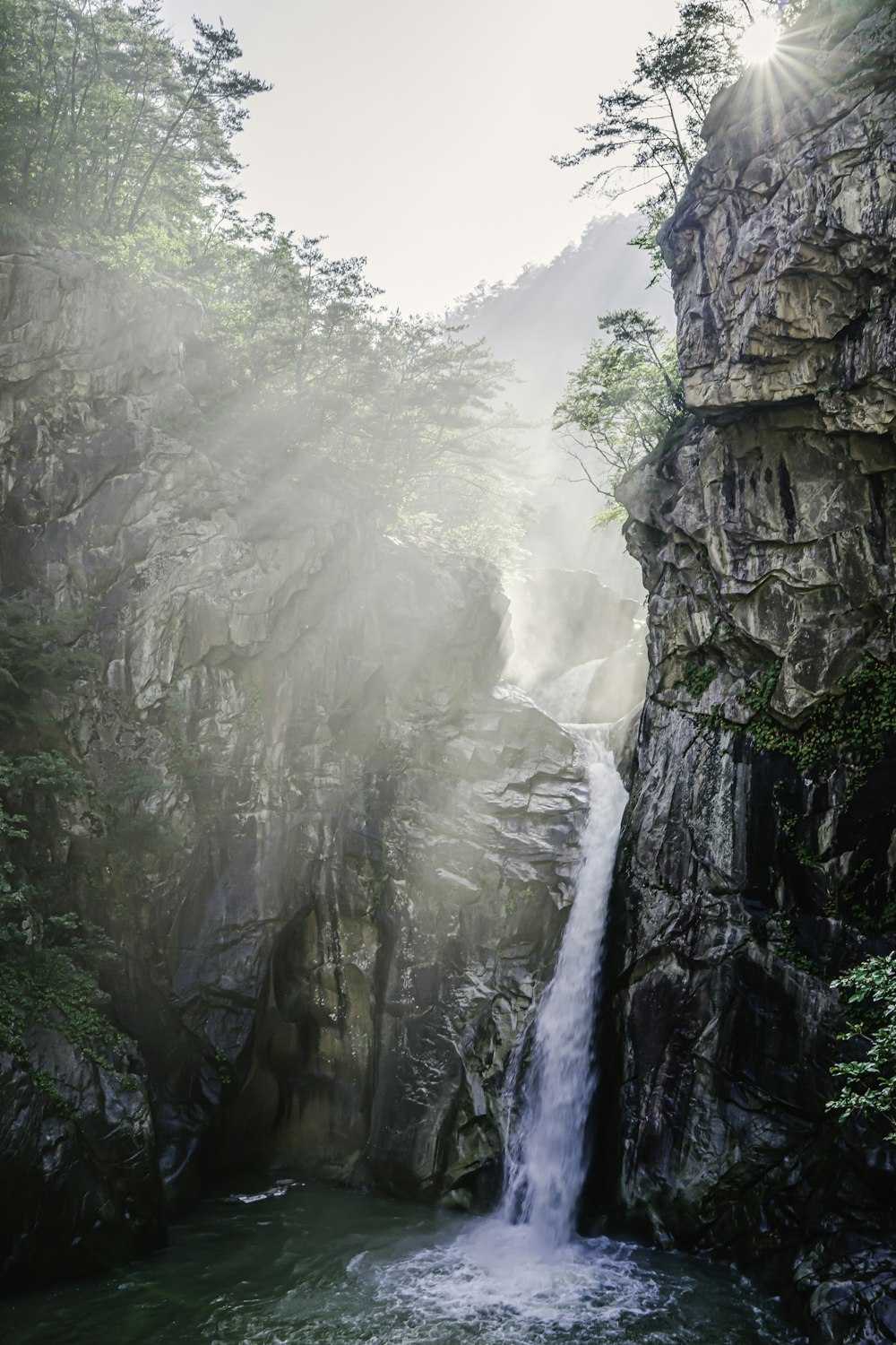 waterfalls on rocky mountain during daytime