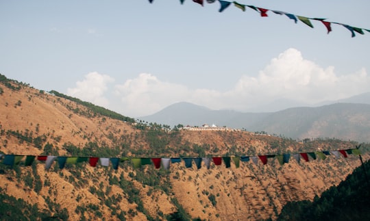 people walking on brown sand during daytime in Thimphu Bhutan