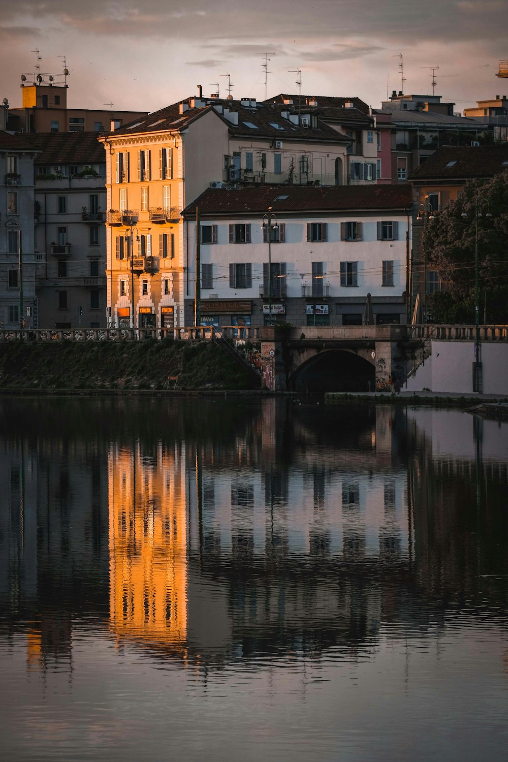 brown and white concrete building beside river during daytime