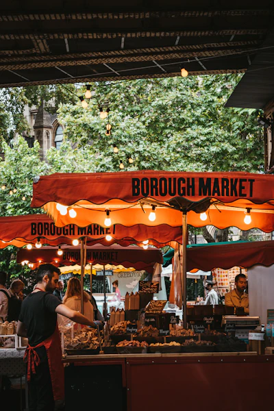 Diners beside a food stall at Borough Market, London