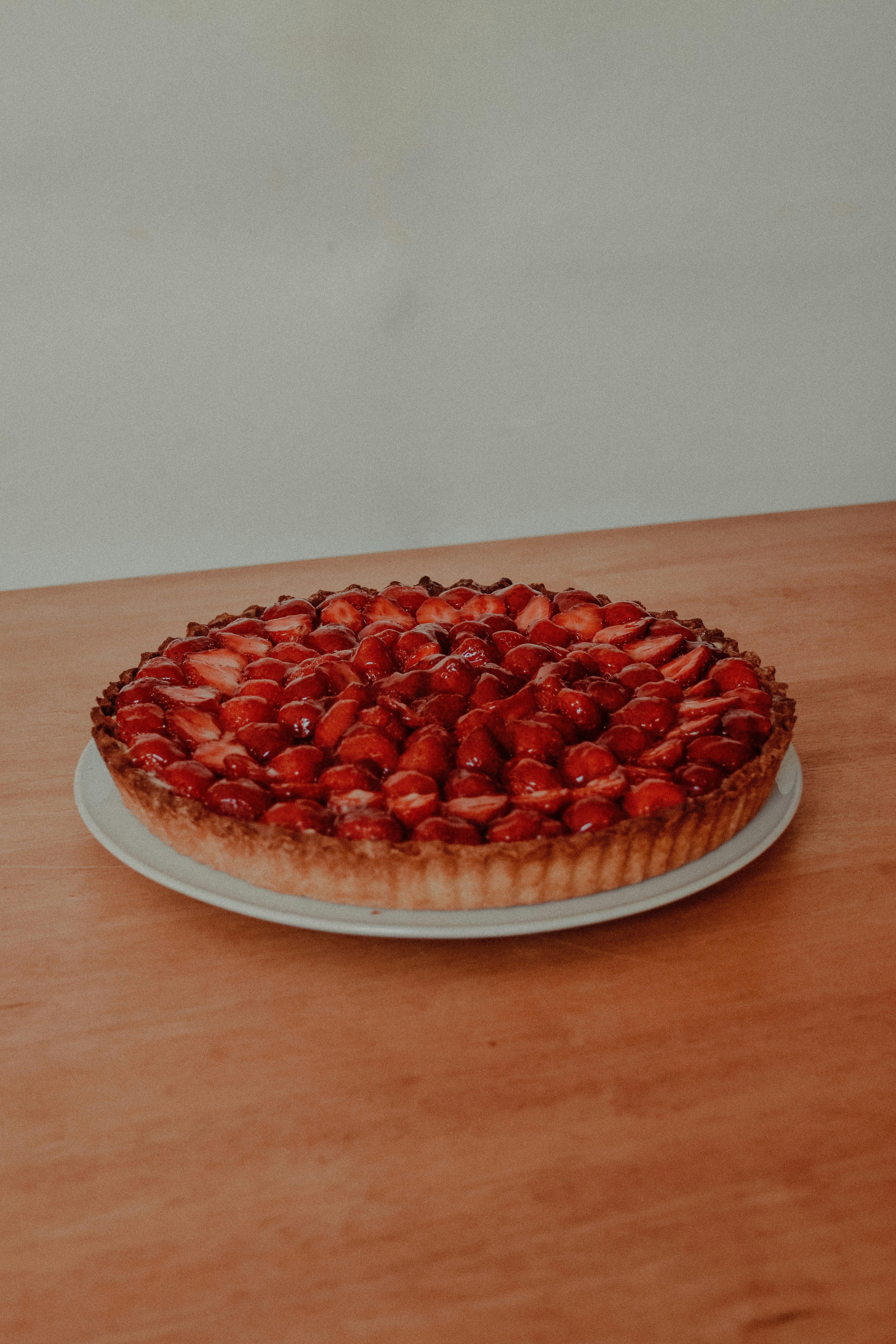 red and white round fruit on brown wooden table