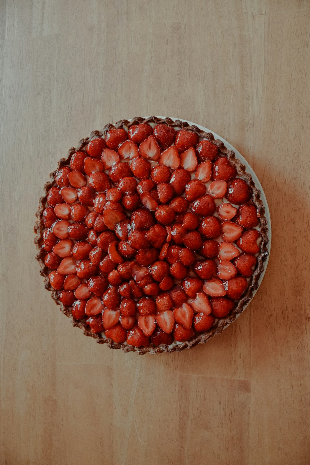 red round fruit on brown wooden table