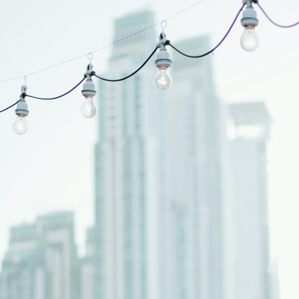 string lights hanged on string during daytime