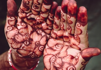 person with red and white floral nail art