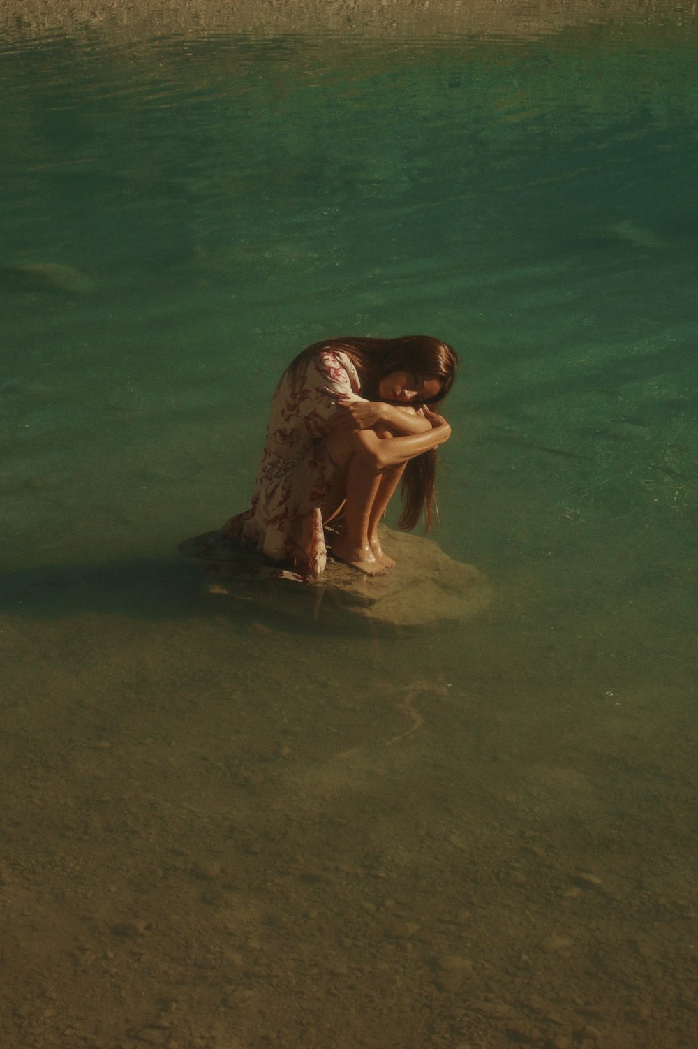 woman in black bikini lying on water