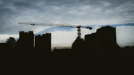 silhouette of buildings under cloudy sky during daytime